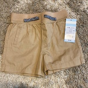 NWT, boys shorts. Tan. Size 6-9 months
